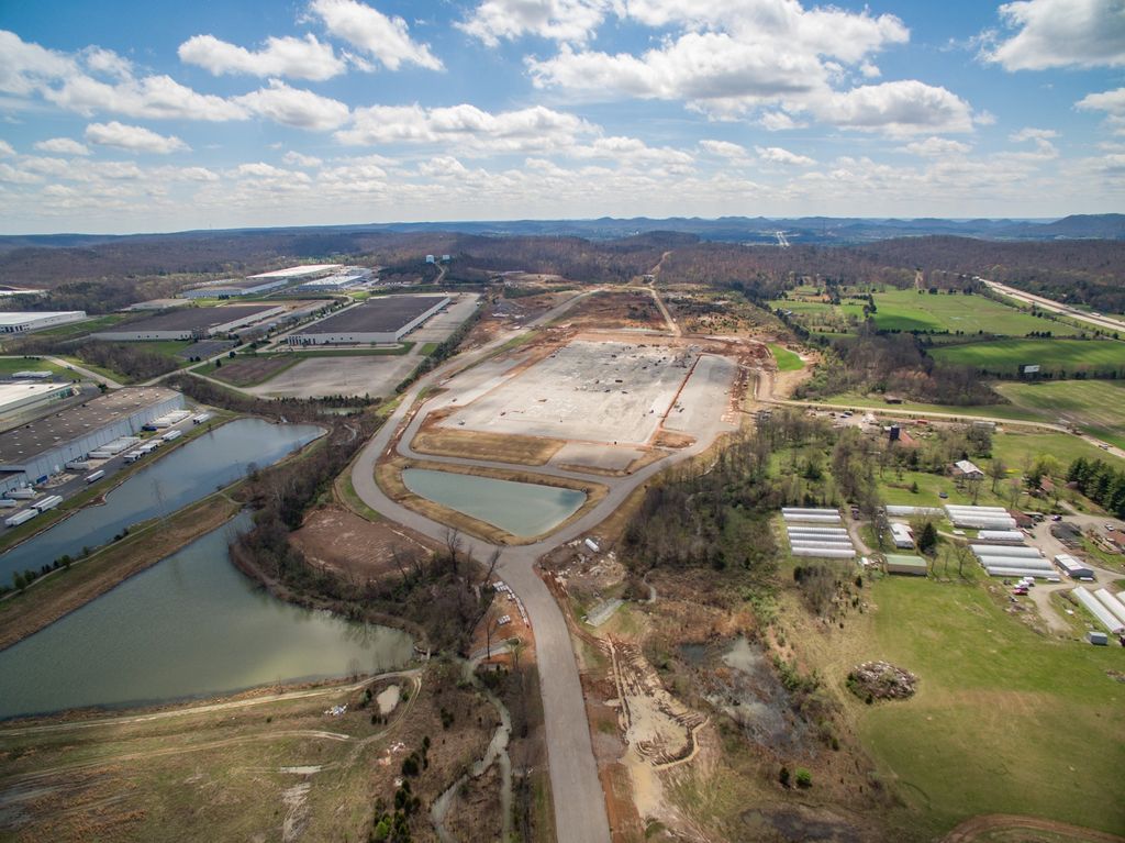 Graded development site with ponds and access roads under construction