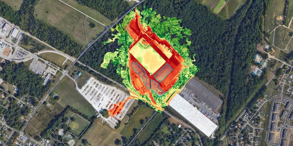 Color-coded elevation layer over a construction site surrounded by woods and neighborhoods