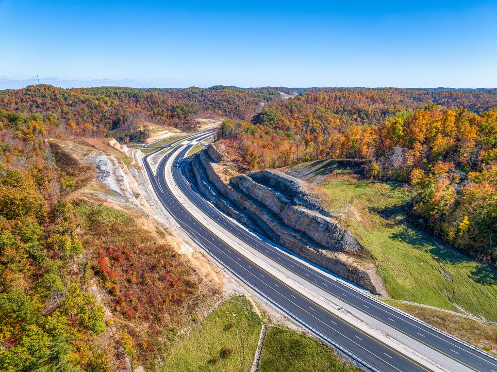 New lanes of the Mountain Parkway curving through autumn hills in eastern Kentucky