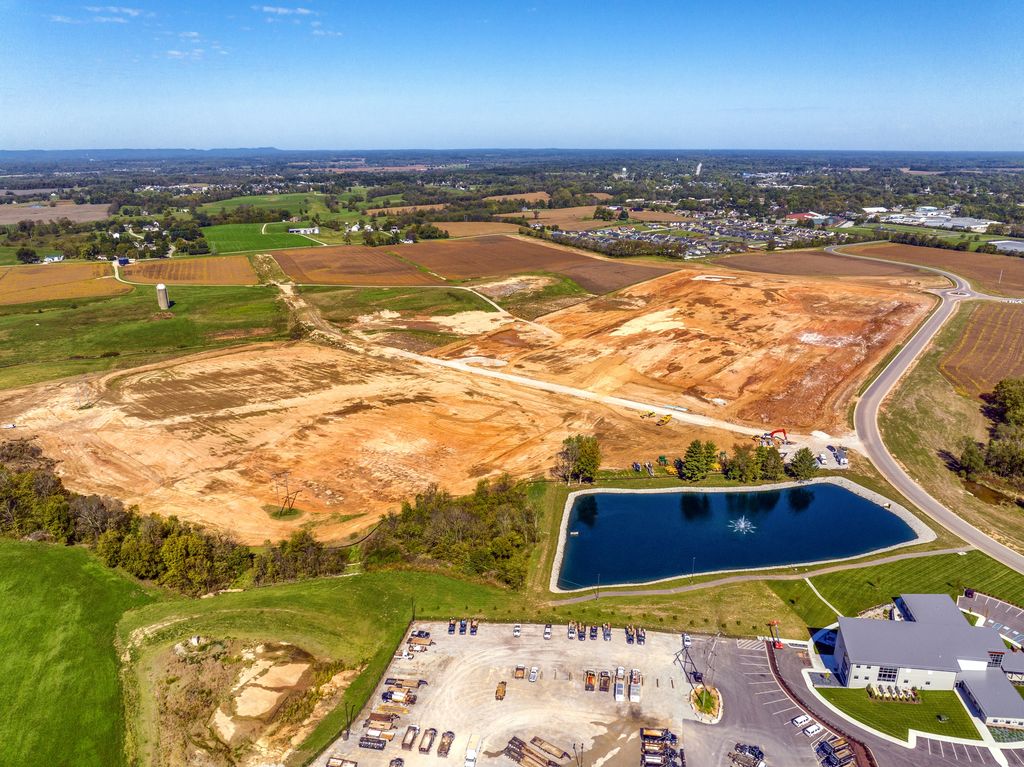Large site being graded for construction beside a retention pond in Southern Indiana