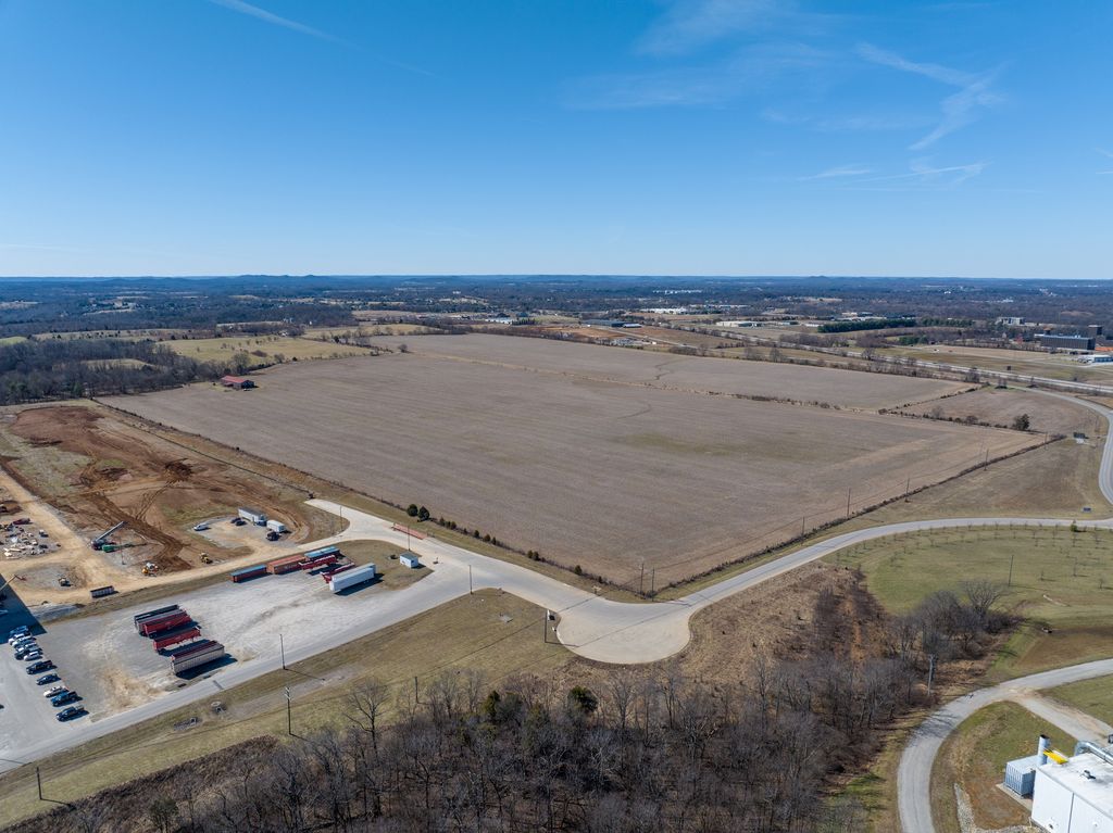 Vacant parcel bordered by a new access road and trailer lot in Bardstown