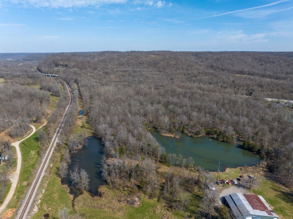 Railway line beside wooded land and a lake near West Point, Kentucky